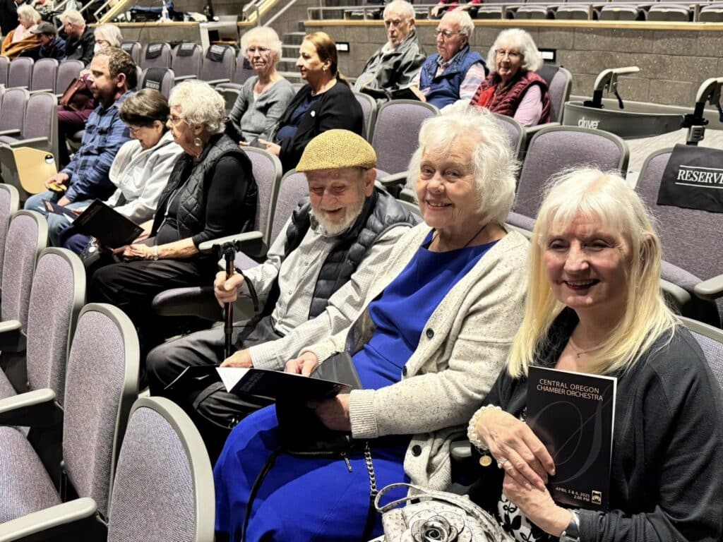 Residents from The Lodge Retirement Community in Sisters, Oregon enjoying an evening out at the Central Oregon Chamber Orchestra, celebrating community and connection.